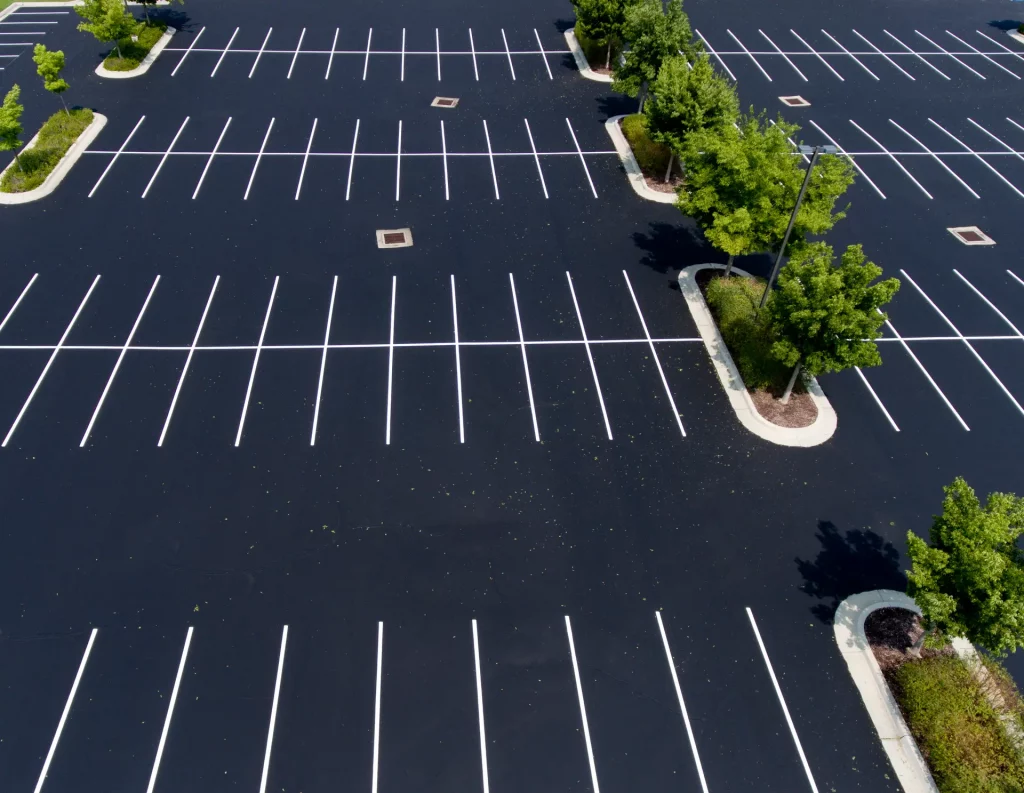 An image showcasing top-quality carpark construction with asphalt surfacing, on a large commercial property  